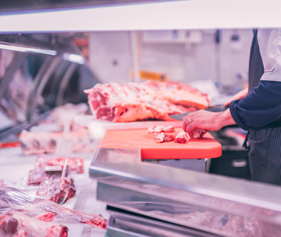 Butcher preparing fresh cuts of meat